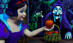 Snow White holds the apple given to her by the wicked witch in Snow White’s Scary Adventure at the Magic Kingdom.